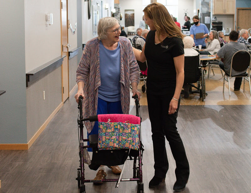 Senior woman with walker caring nurse